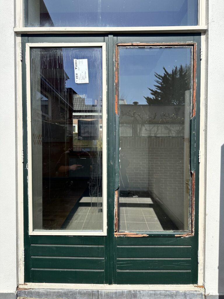 Green double door with glass panels
